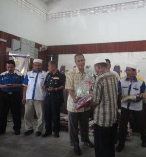 PEGAWAI Daerah SPU, Jusni Ismail (empat dari kiri) menyampaikan sumbangan hamper kepada salah seorang penerima sambil diperhatikan oleh Rosidi Hussain (kiri sekali) bersempena Majlis Mesra Rakyat Program PPRT di sini baru-baru ini.