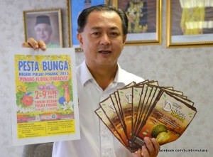 Law with flyers of the Penang Durian Festival and Penang Floral.