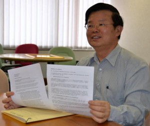 CHOW Kon Yeow menunjukkan dokumen berhubung penjelasan isu pembangunan lereng bukit di sini baru-baru ini.