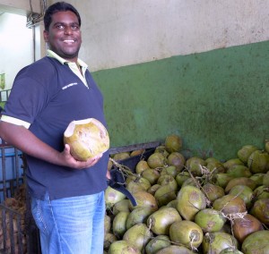 Joez is very adept with chopping fresh coconuts to be handed out to  thirsty customers.