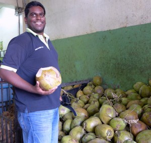 Joez is very adept with chopping fresh coconuts to be handed out to thirsty customers.